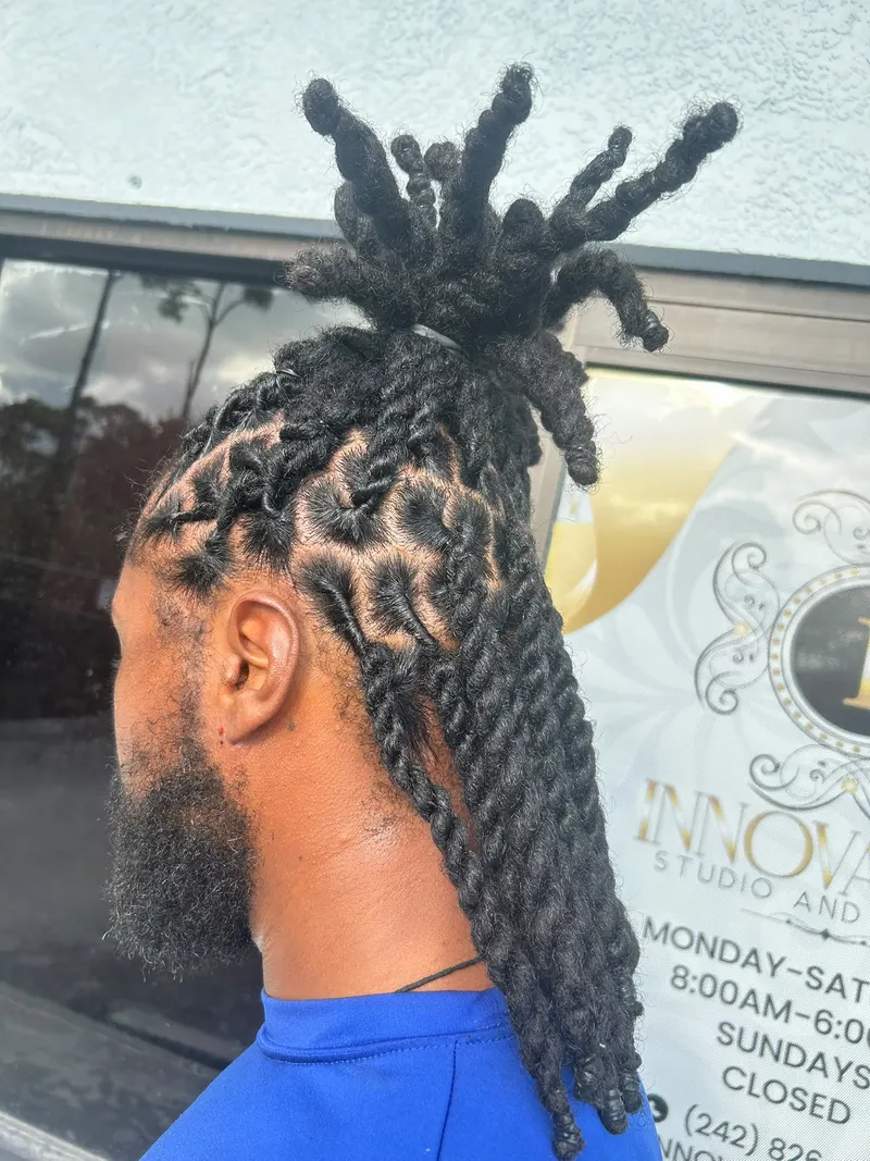 Locs gathered into a high bun, profile view