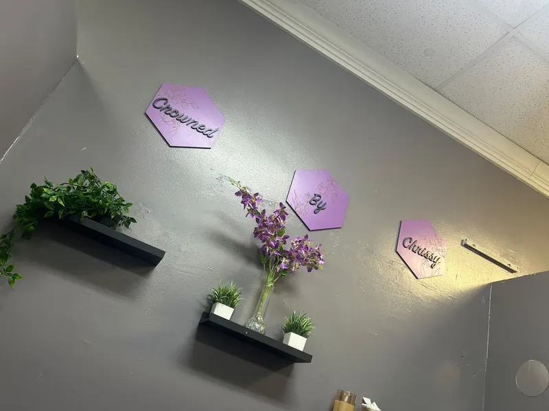 Purple hexagon signs reading Crowned By Chrissy